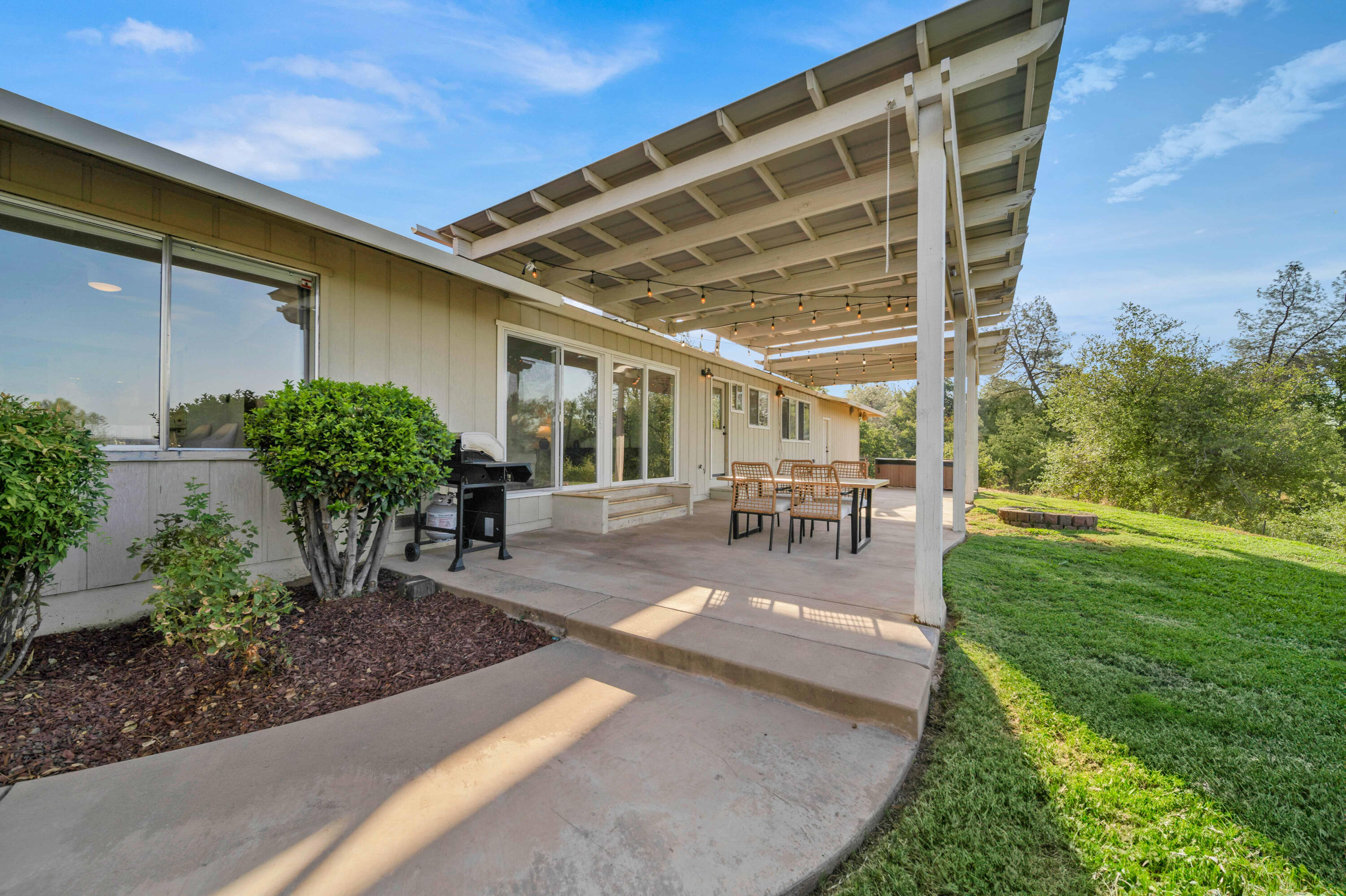 1705 Barbara Road Redding, CA 96003 - Photo 87 of 103 a view of a patio with table and chairs potted plants and floor to ceiling window