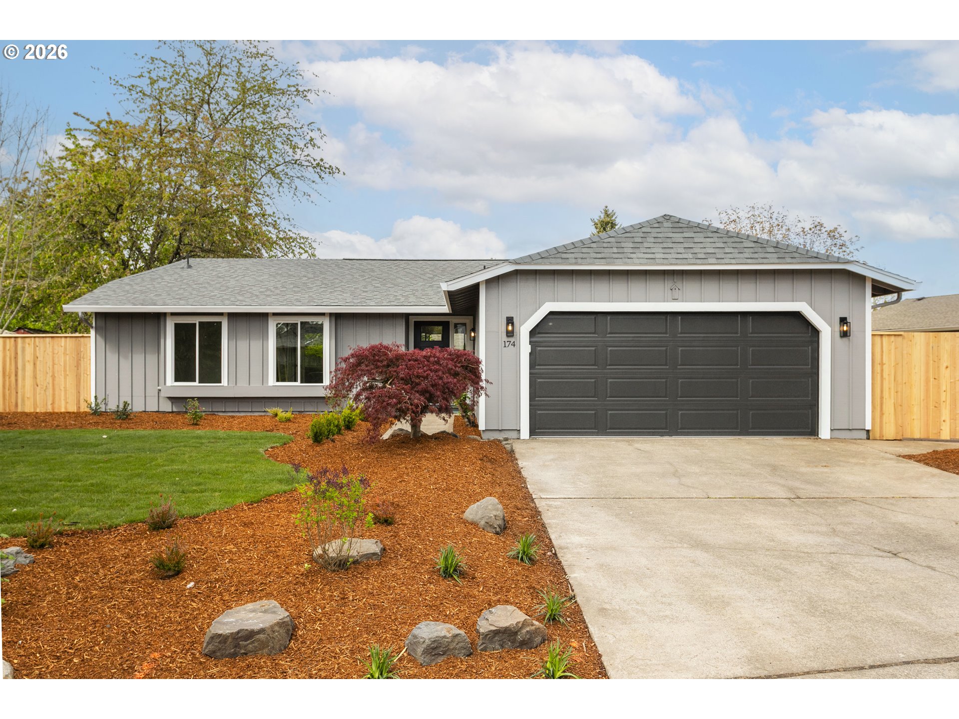 174 Southwest 10th Avenue Canby, OR 97013 - Photo 1 of 31 a front view of a house with a yard and garage