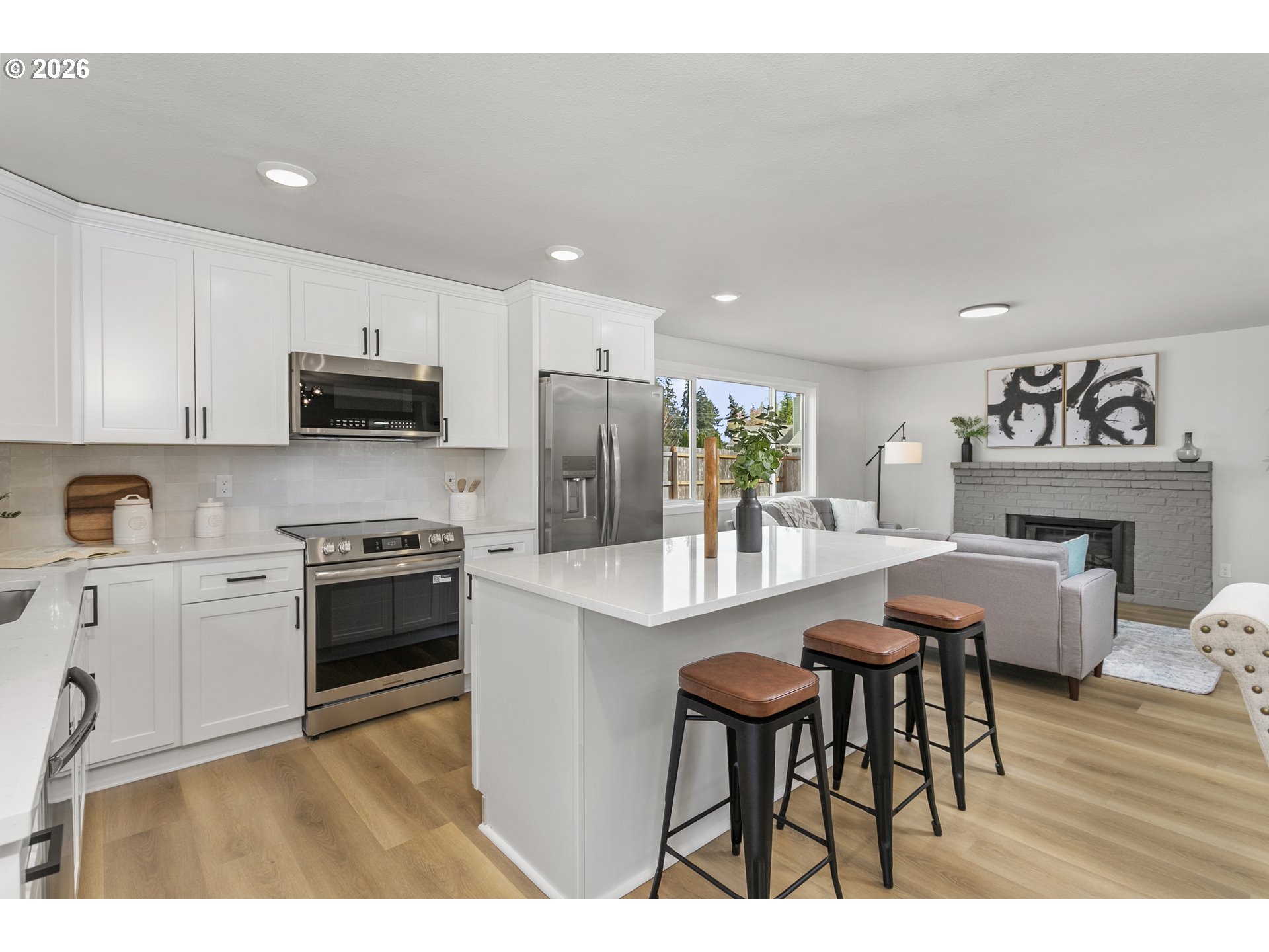 174 Southwest 10th Avenue Canby, OR 97013 - Photo 12 of 31 a kitchen with stainless steel appliances a dining table chairs stove refrigerator and cabinets