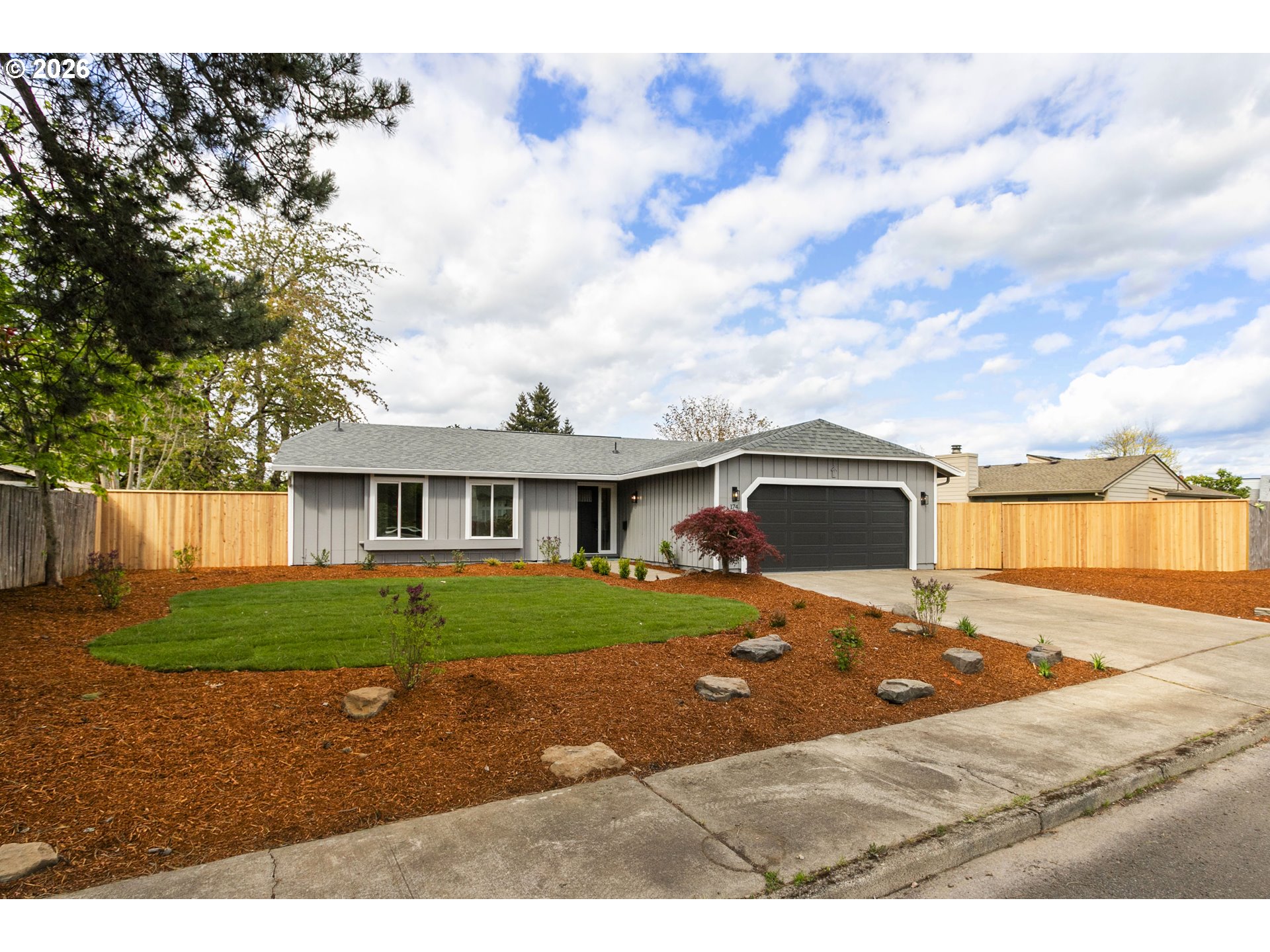 174 Southwest 10th Avenue Canby, OR 97013 - Photo 2 of 31 a front view of a house with a yard and garage