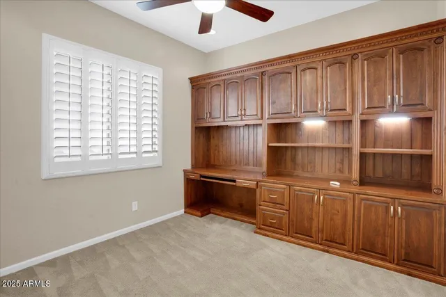 a kitchen with granite countertop wooden cabinets and a sink