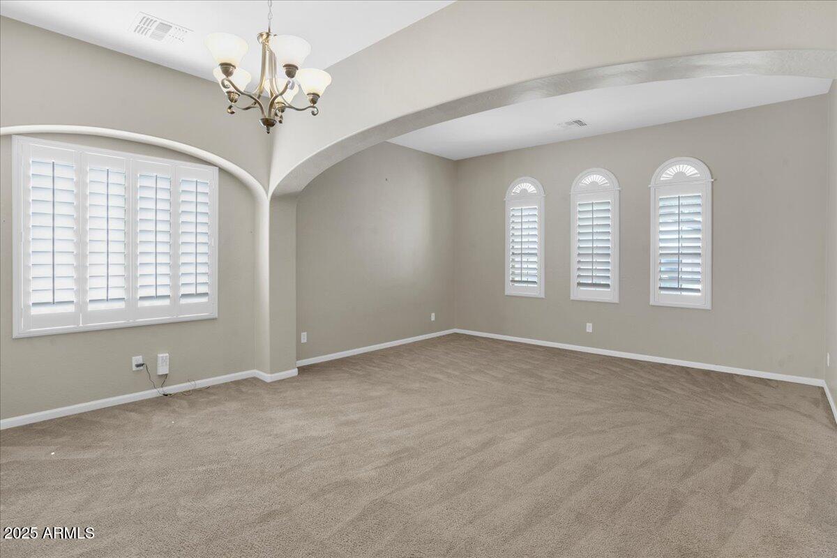 2410 East Park View Lane Phoenix, AZ 85024 - Photo 14 of 15 an empty room with windows and chandelier fan