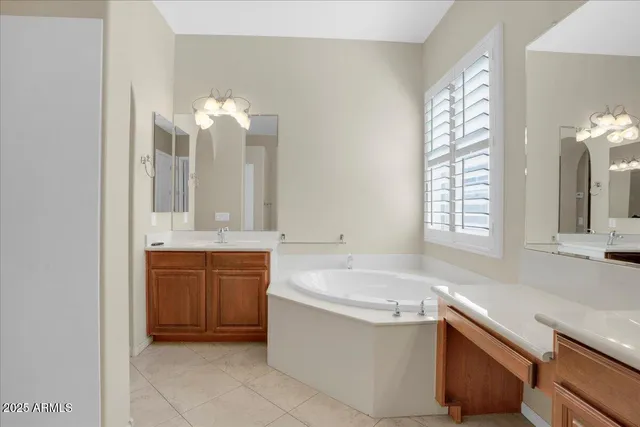a bathroom with a tub sink and mirror