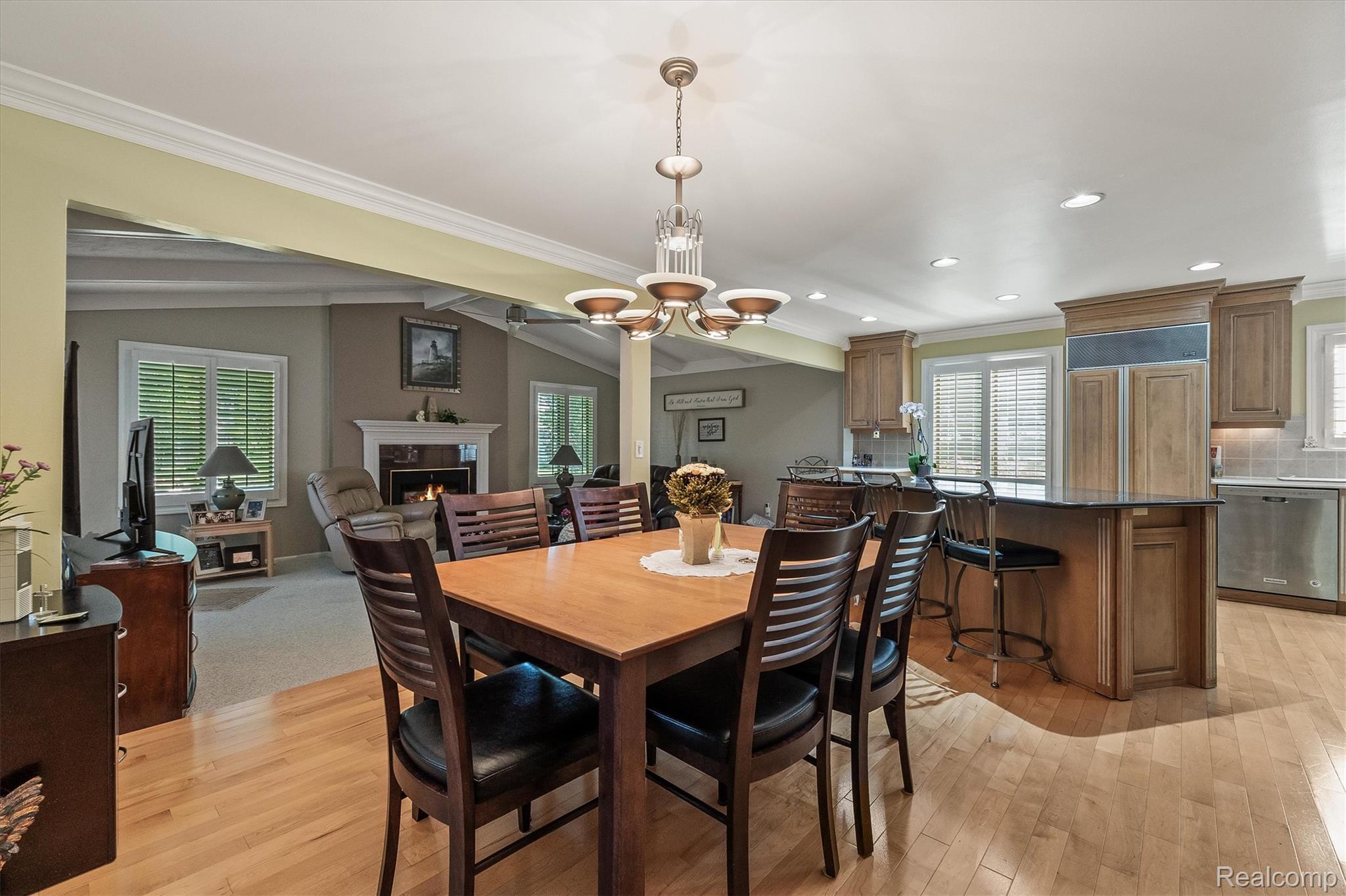 1662 Sumac Drive Rochester, MI 48309 - Photo 9 of 38 Open-concept dining area featuring wood-finish flooring, a contemporary chandelier, and recessed lighting