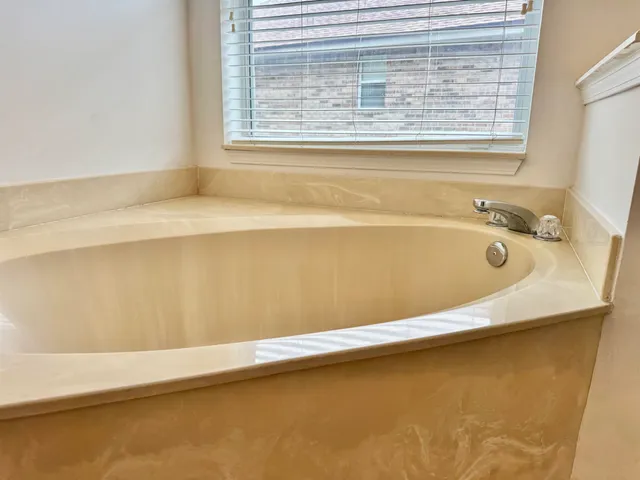 a bath tub sitting next to a window