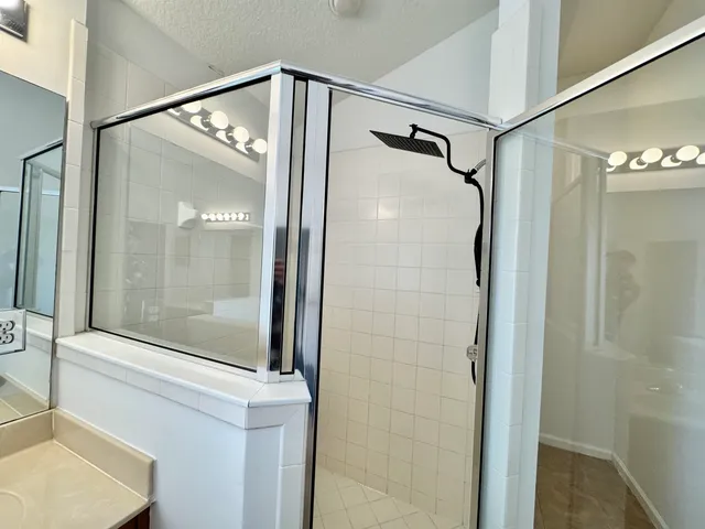 a bathroom with a glass shower door