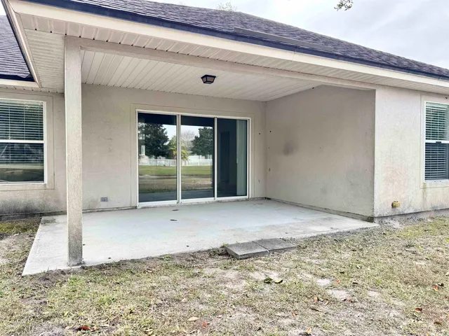 a front view of a house with yard and trees