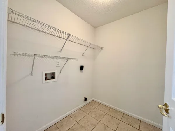 a view of a room with window and chandelier