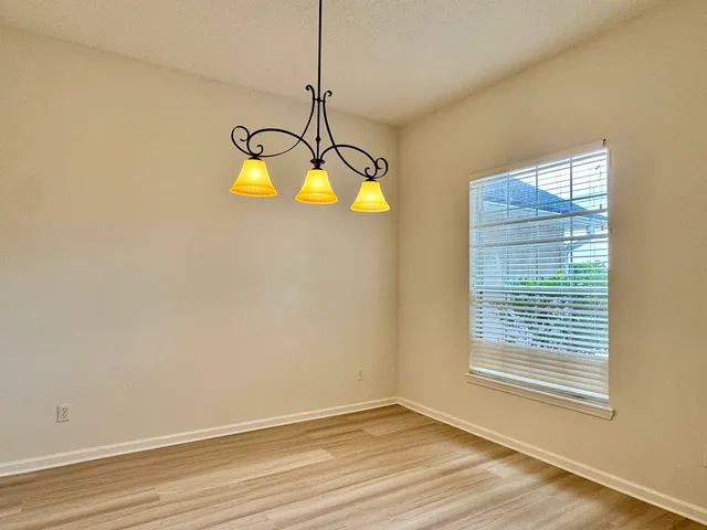 a view of a room with window and chandelier