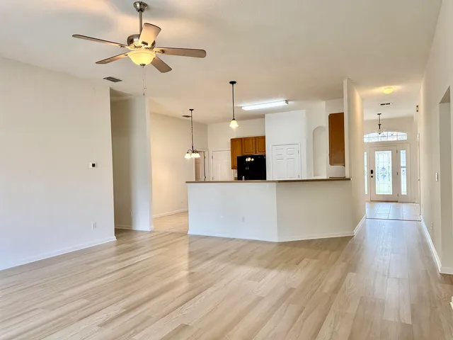 a view of kitchen with cabinets appliances and wooden floor