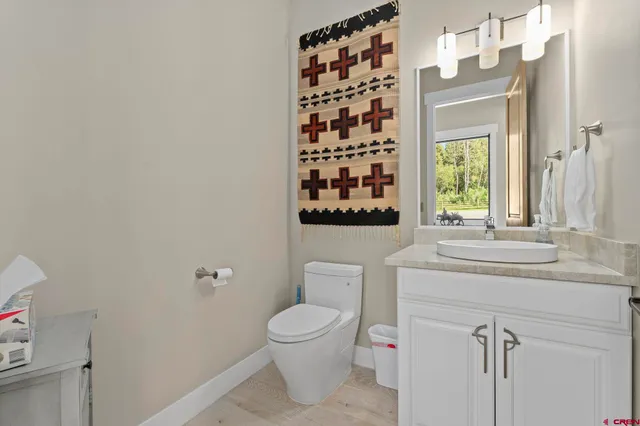 a bathroom with a toilet a sink and a window