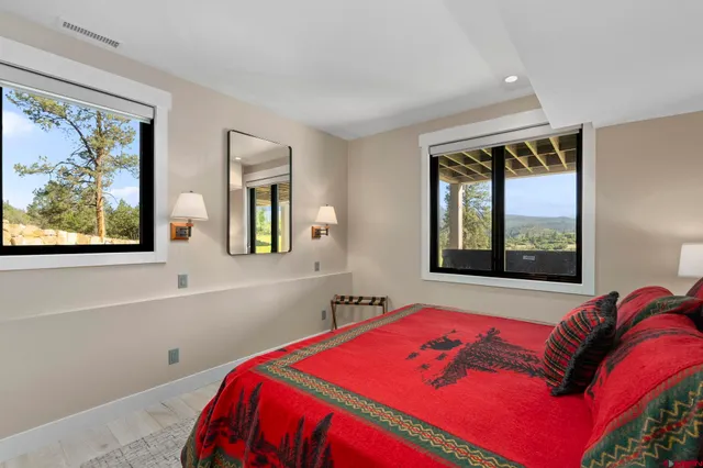 a bedroom with a bed and a painting on the wall
