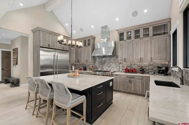 a view of a lush green field with mountains in the background