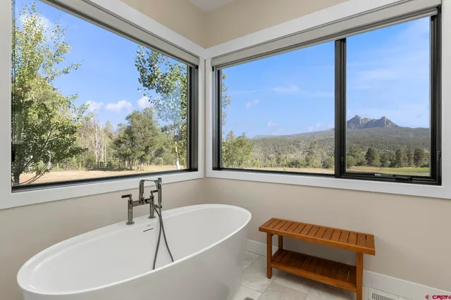 a bathroom with a window sink and mirror