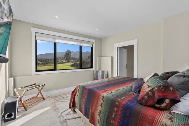 a view of a lake with a table and chairs