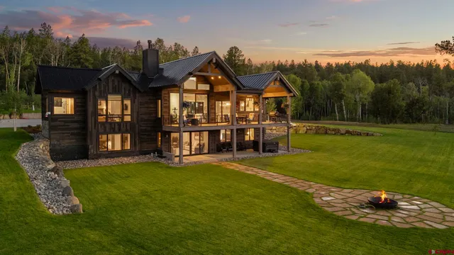 a kitchen with refrigerator a sink and chairs