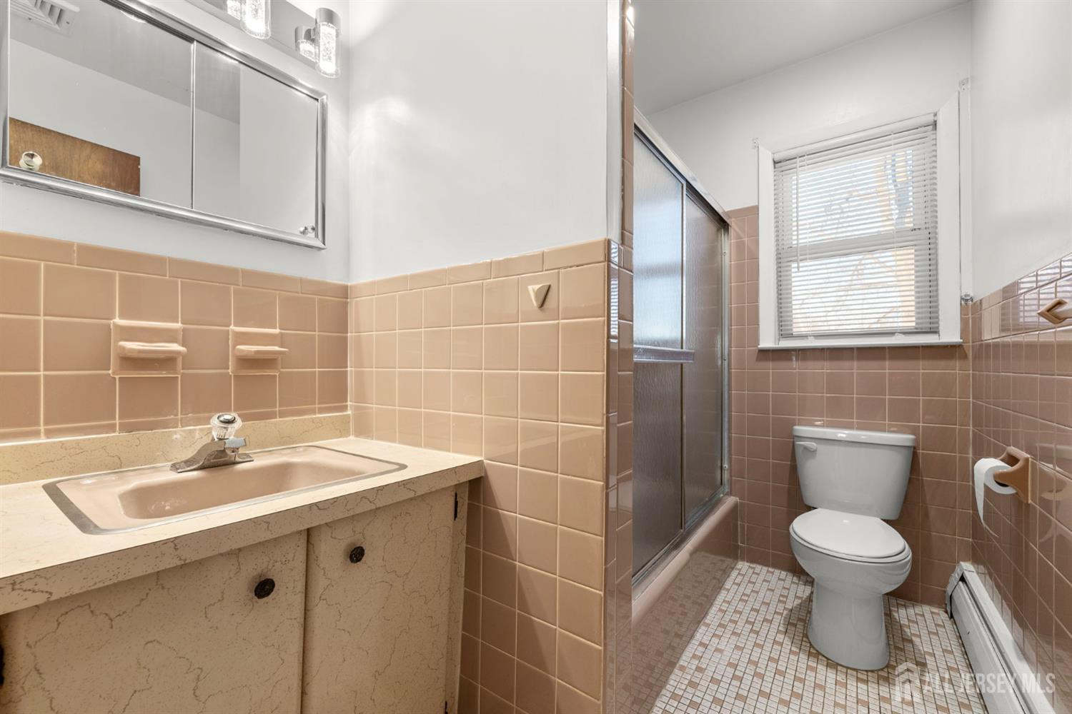 2291 Morrison Avenue Union, NJ 07083 - Photo 15 of 28 a bathroom with a sink toilet and a mirror