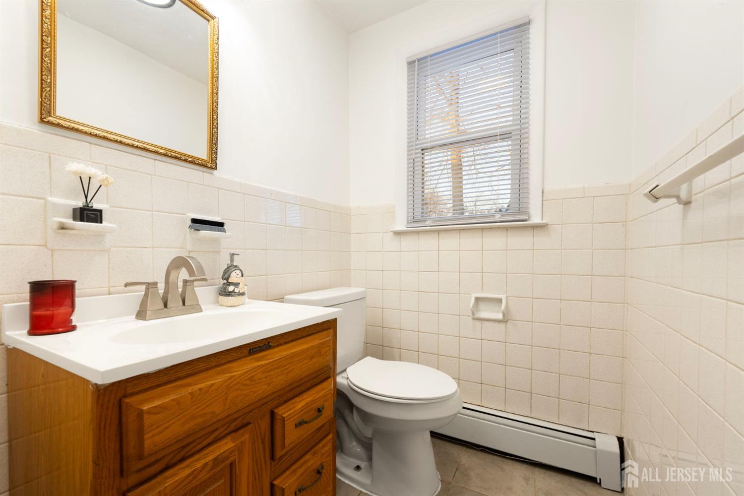 2291 Morrison Avenue Union, NJ 07083 - Photo 18 of 28 a bathroom with a sink a toilet and mirror