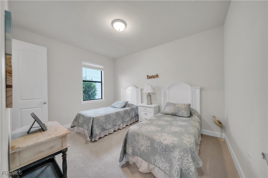 19918 Beverly Park Road Estero, FL 33928 - Photo 19 of 46 a bedroom with two beds and a window