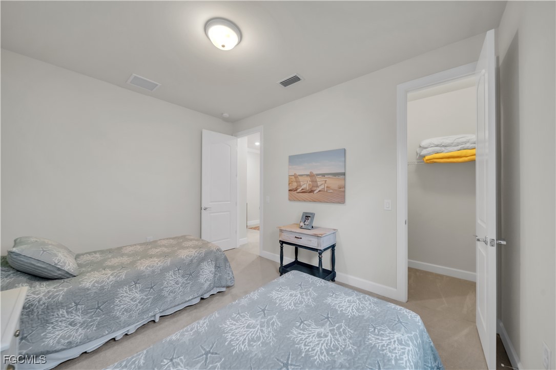 19918 Beverly Park Road Estero, FL 33928 - Photo 20 of 46 a bedroom with a bed and a lamp on table