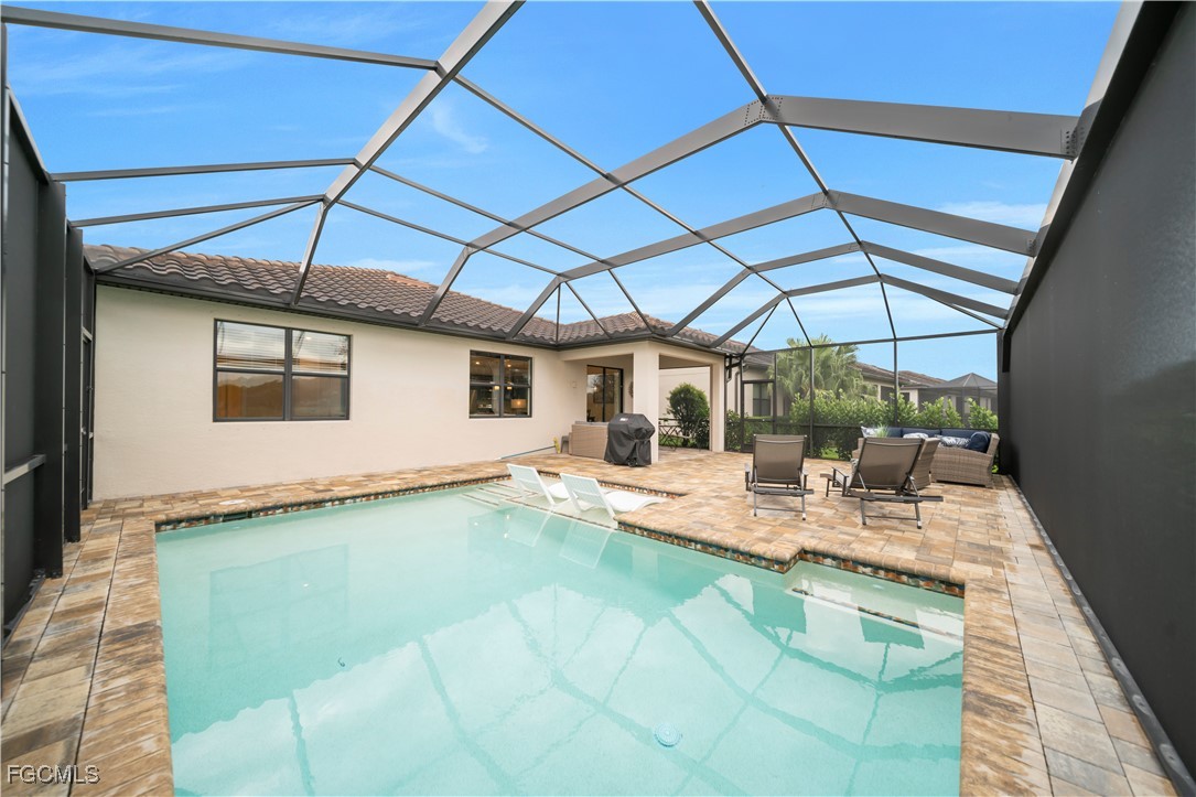 19918 Beverly Park Road Estero, FL 33928 - Photo 25 of 46 a view of a patio with table and chairs under an umbrella