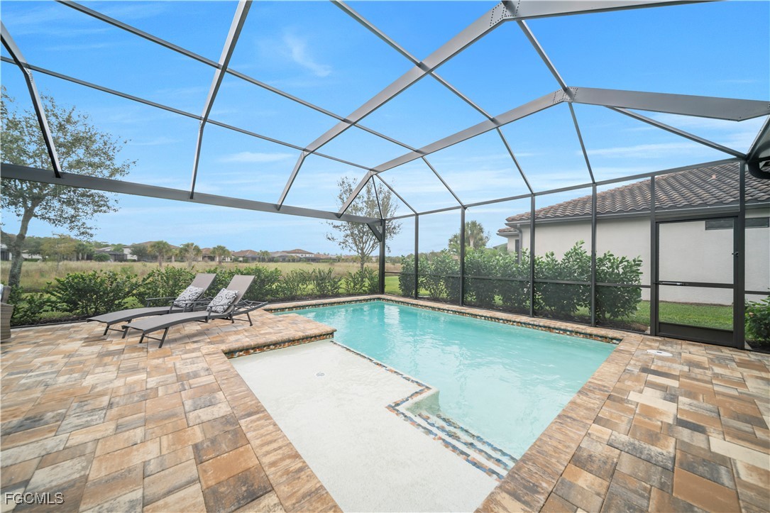 19918 Beverly Park Road Estero, FL 33928 - Photo 28 of 46 a view of a swimming pool with a patio