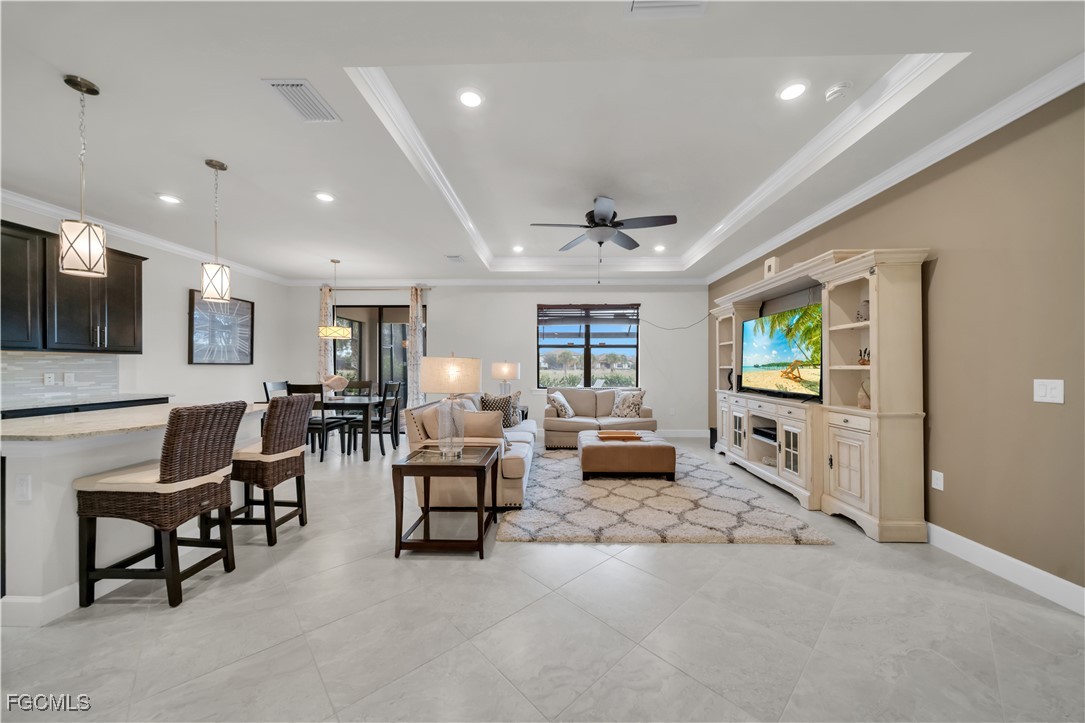 19918 Beverly Park Road Estero, FL 33928 - Photo 3 of 46 a living room with furniture and a flat screen tv