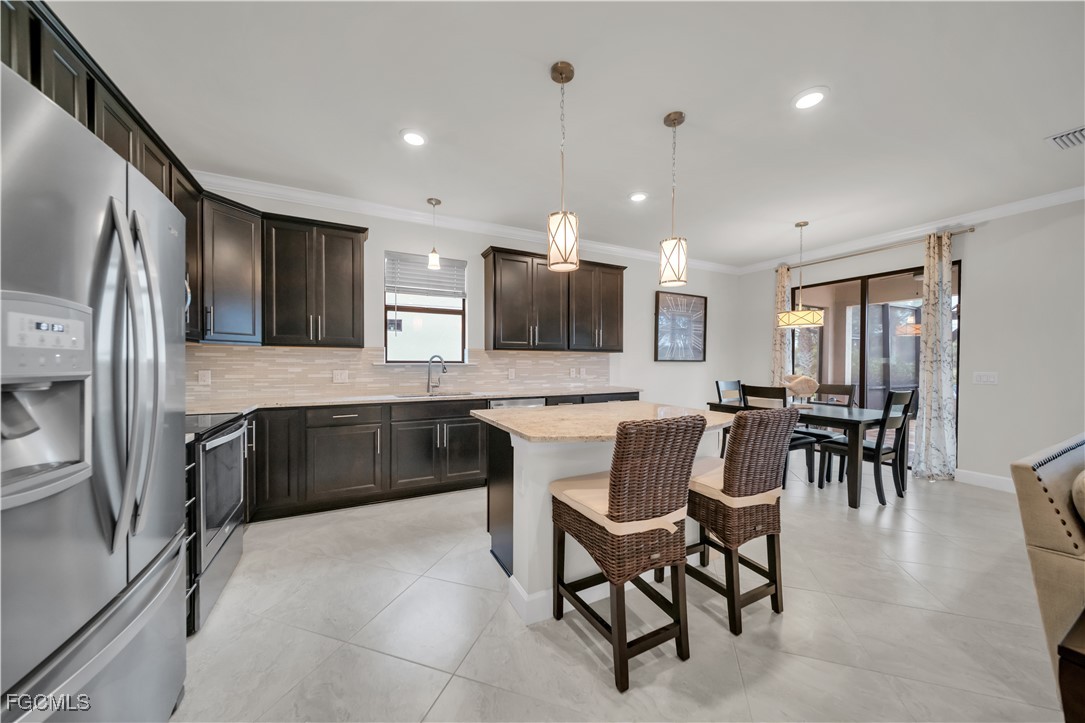 19918 Beverly Park Road Estero, FL 33928 - Photo 5 of 46 a large kitchen with a table and chairs