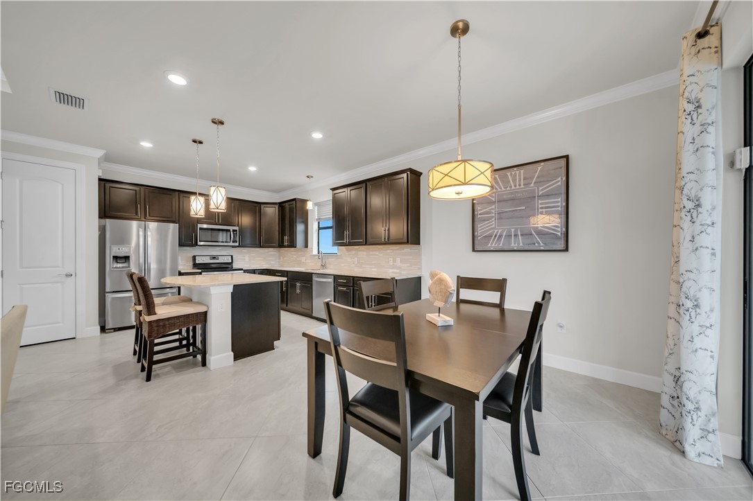 19918 Beverly Park Road Estero, FL 33928 - Photo 7 of 46 a view of a dining room with furniture