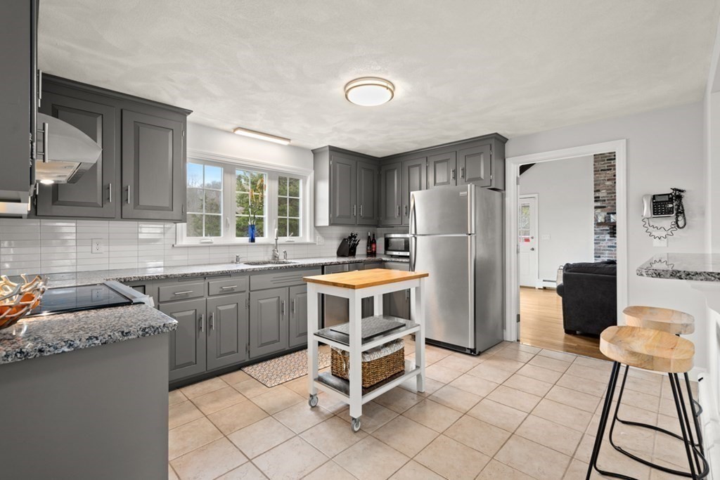 1091 Bay Road Hamilton, MA 01982 - Photo 13 of 40 a kitchen with a cabinets and a refrigerator