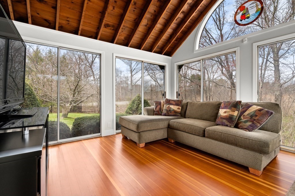 1091 Bay Road Hamilton, MA 01982 - Photo 20 of 40 a living room with furniture a large window with wooden floor