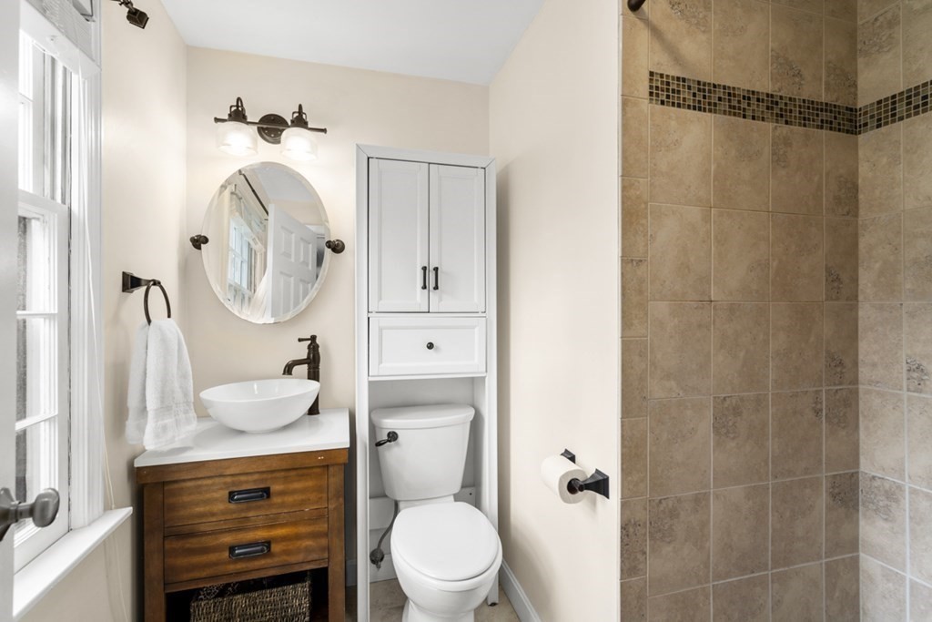 1091 Bay Road Hamilton, MA 01982 - Photo 25 of 40 a bathroom with a sink a toilet and a mirror
