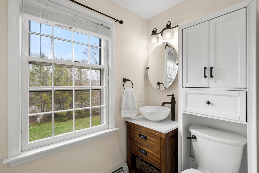 1091 Bay Road Hamilton, MA 01982 - Photo 26 of 40 a bathroom with a granite countertop sink a mirror and shower