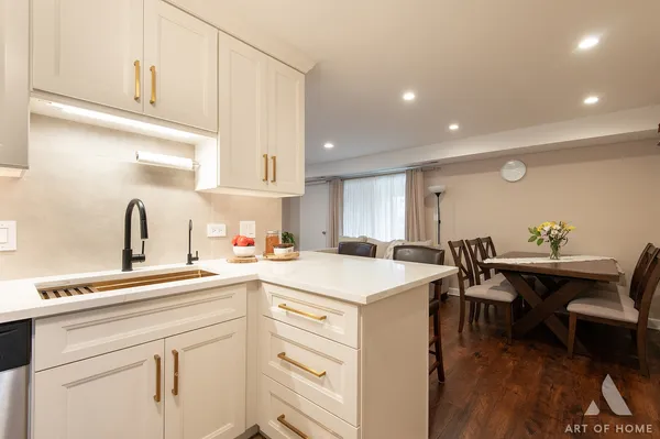 a kitchen with a sink a stove a dining table and chairs