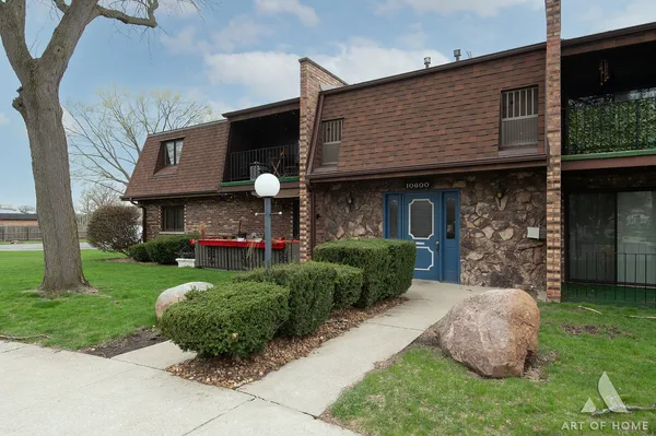 a front view of a house with a garden