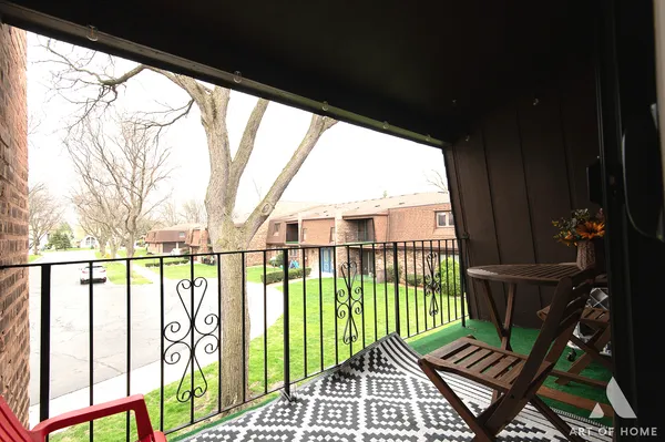 a view of a balcony with wooden floor
