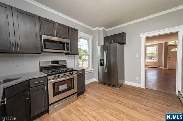 a kitchen with stainless steel appliances granite countertop a refrigerator stove and microwave