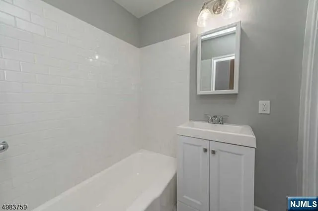 a bathroom with a sink a toilet and vanity