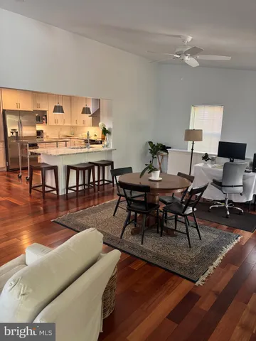 a view of a dining room with furniture and wooden floor