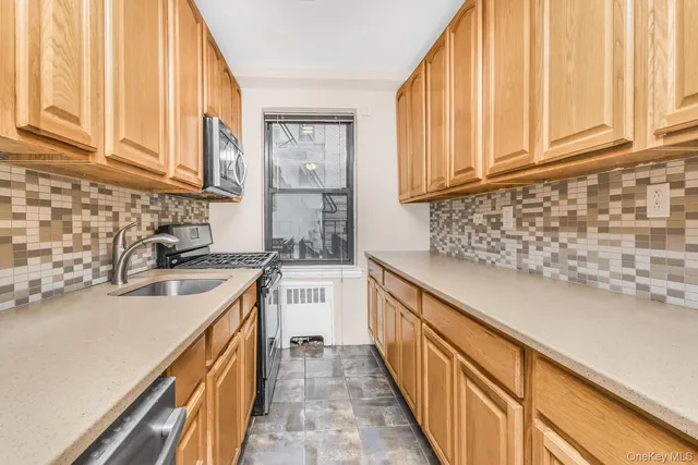 a kitchen with sink cabinets and window