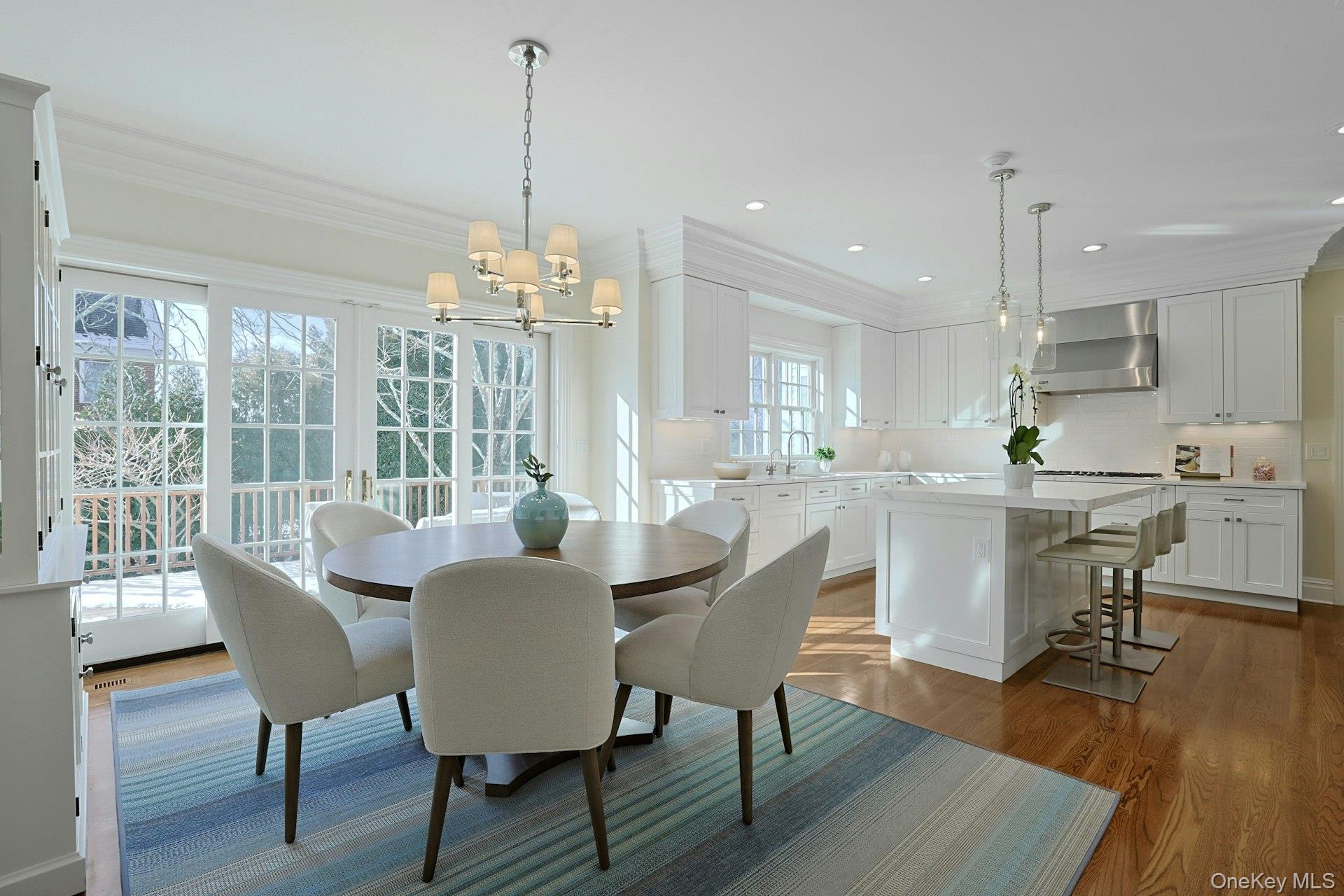 24 Fairview Road Scarsdale, NY 10583 - Photo 12 of 48 Sun-filled dining area with sliders to the mahogany deck, creating effortless indoor-outdoor living for casual meals and easy entertaining.