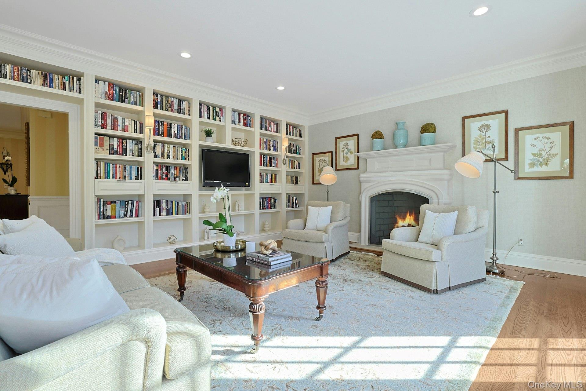 24 Fairview Road Scarsdale, NY 10583 - Photo 14 of 48 A second view highlights the impressive wall of custom built-in cabinetry and bookshelves, offering both beauty and exceptional storage.