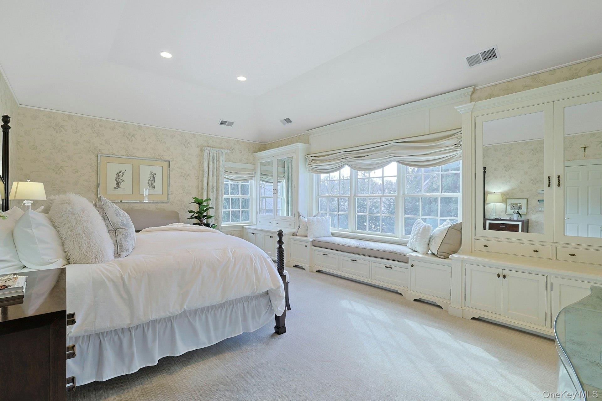 24 Fairview Road Scarsdale, NY 10583 - Photo 21 of 48 Another view of the primary bedroom highlights the expansive layout, wall of windows, and thoughtful design that create a peaceful sanctuary.