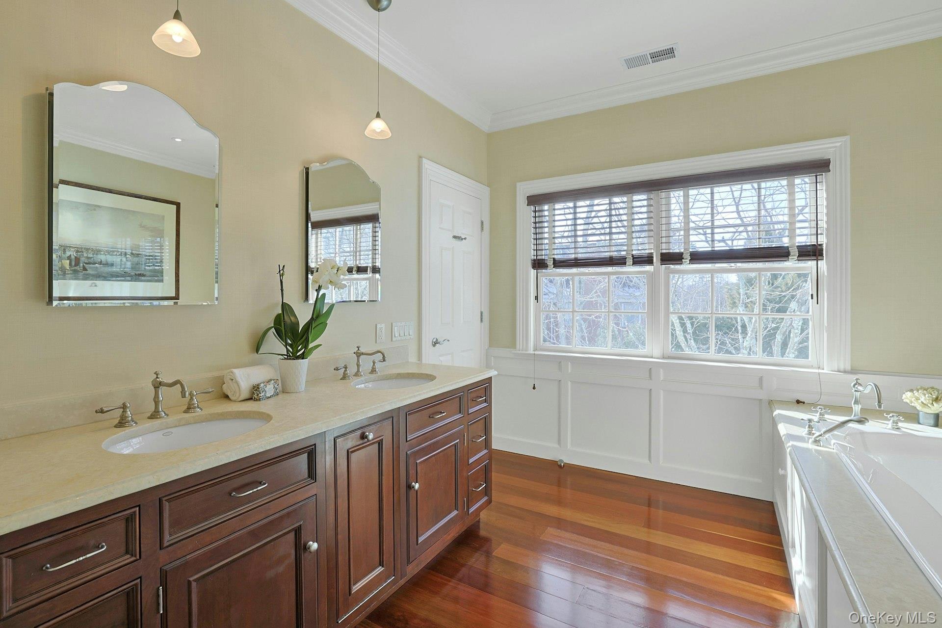 24 Fairview Road Scarsdale, NY 10583 - Photo 22 of 48 Spa-inspired, luxurious ensuite primary bath featuring a double vanity, rich Brazilian cherry floors, relaxing Jacuzzi soaking tub, and separate steam shower.