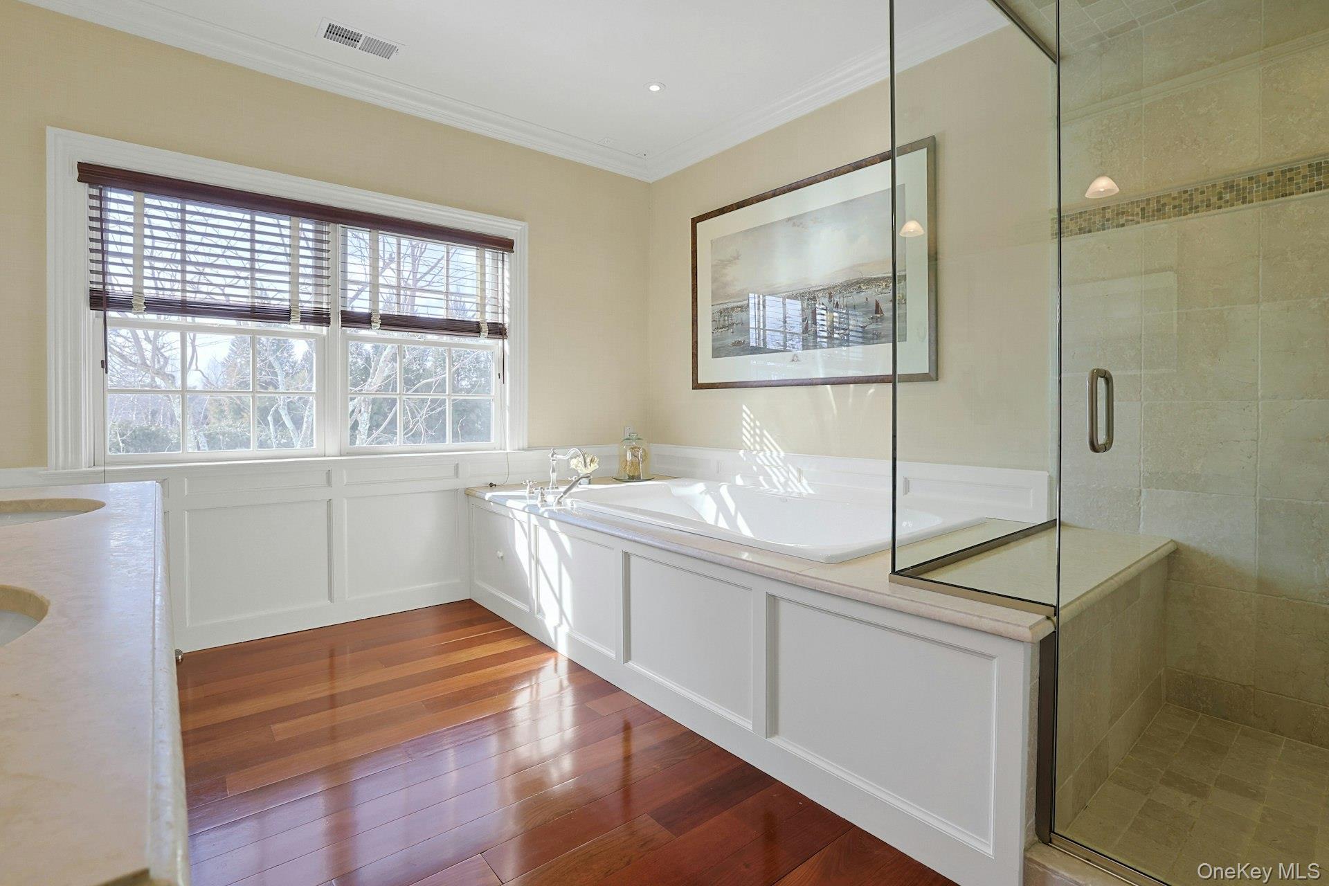 24 Fairview Road Scarsdale, NY 10583 - Photo 23 of 48 Another view of the luxurious primary bath with Jacuzzi soaking tub, steam shower, and Brazilian cherry flooring.