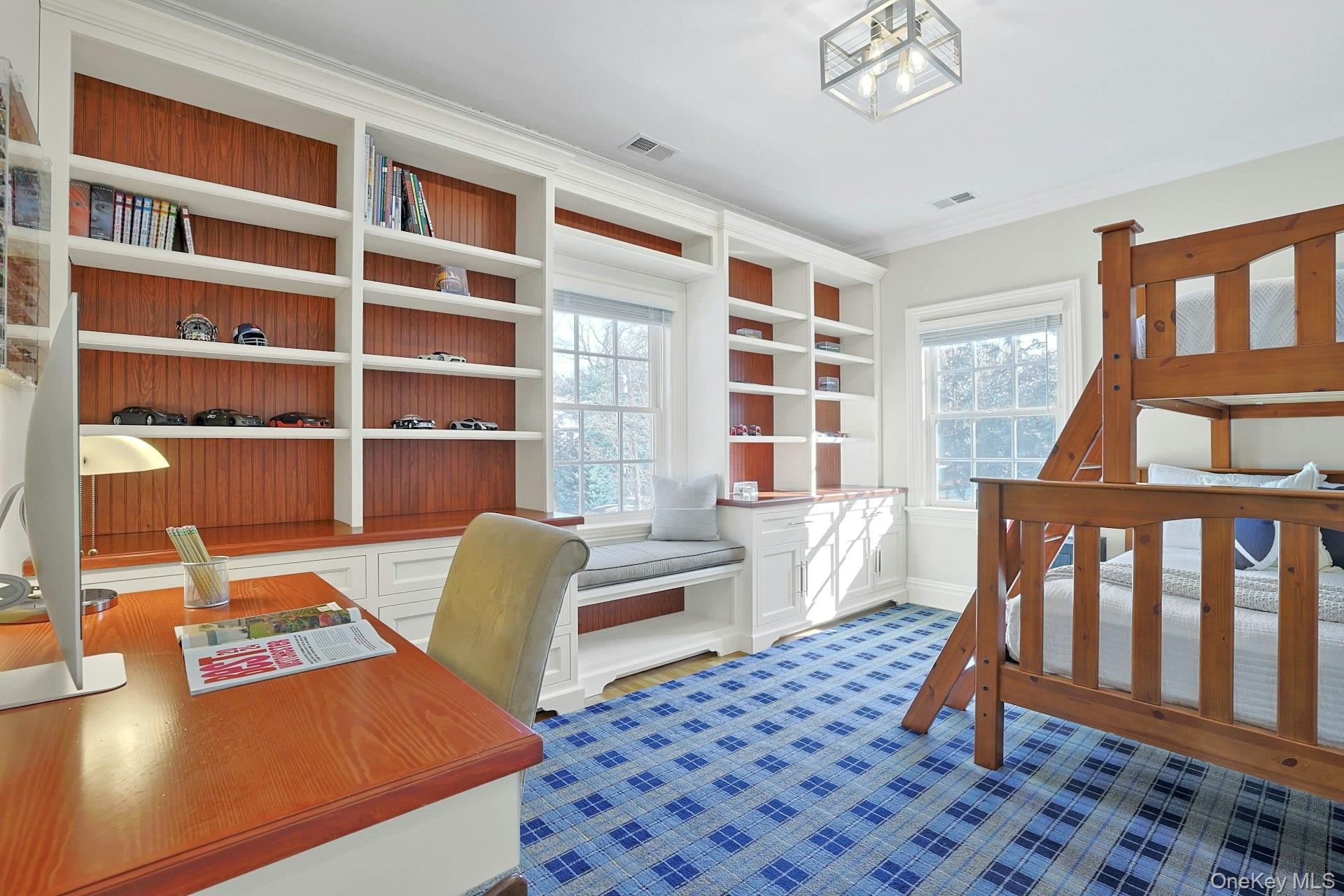 24 Fairview Road Scarsdale, NY 10583 - Photo 24 of 48 A bright and versatile bedroom featuring custom built-in shelving and generous space for sleep, study, and play.