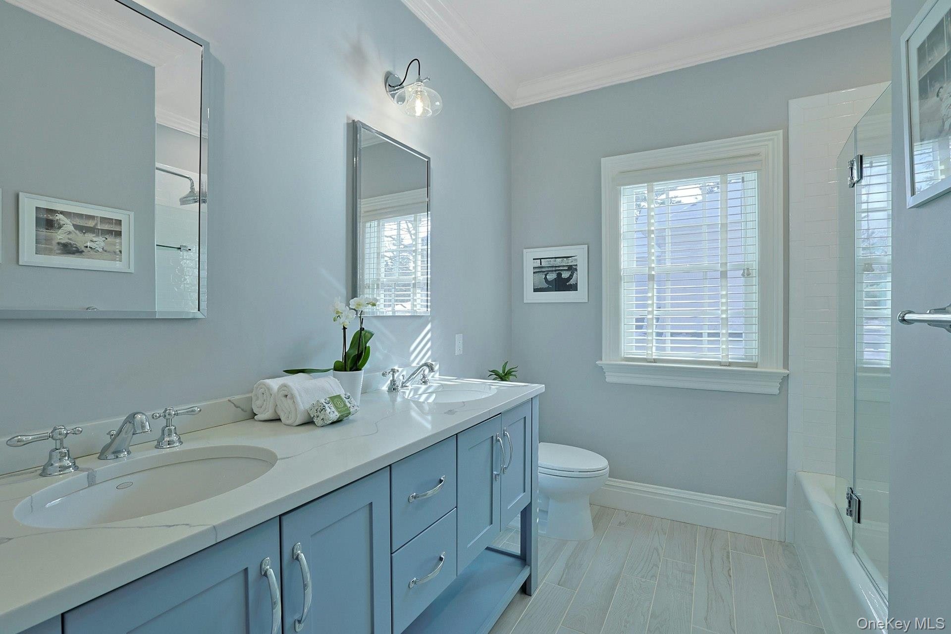 24 Fairview Road Scarsdale, NY 10583 - Photo 25 of 48 A beautifully refreshed bath offering double sinks and a bright, modern aesthetic.