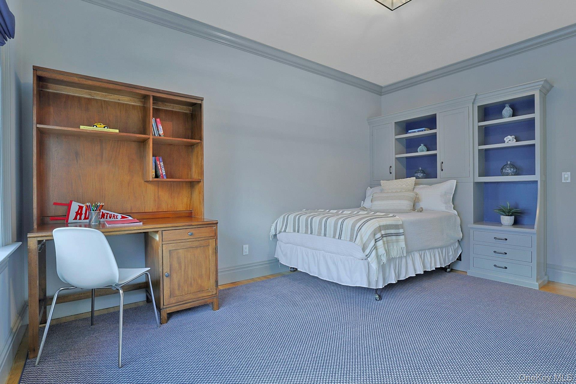 24 Fairview Road Scarsdale, NY 10583 - Photo 26 of 48 Thoughtfully designed with custom built-ins and excellent closet storage, this bedroom is ideal for study, rest, and play.