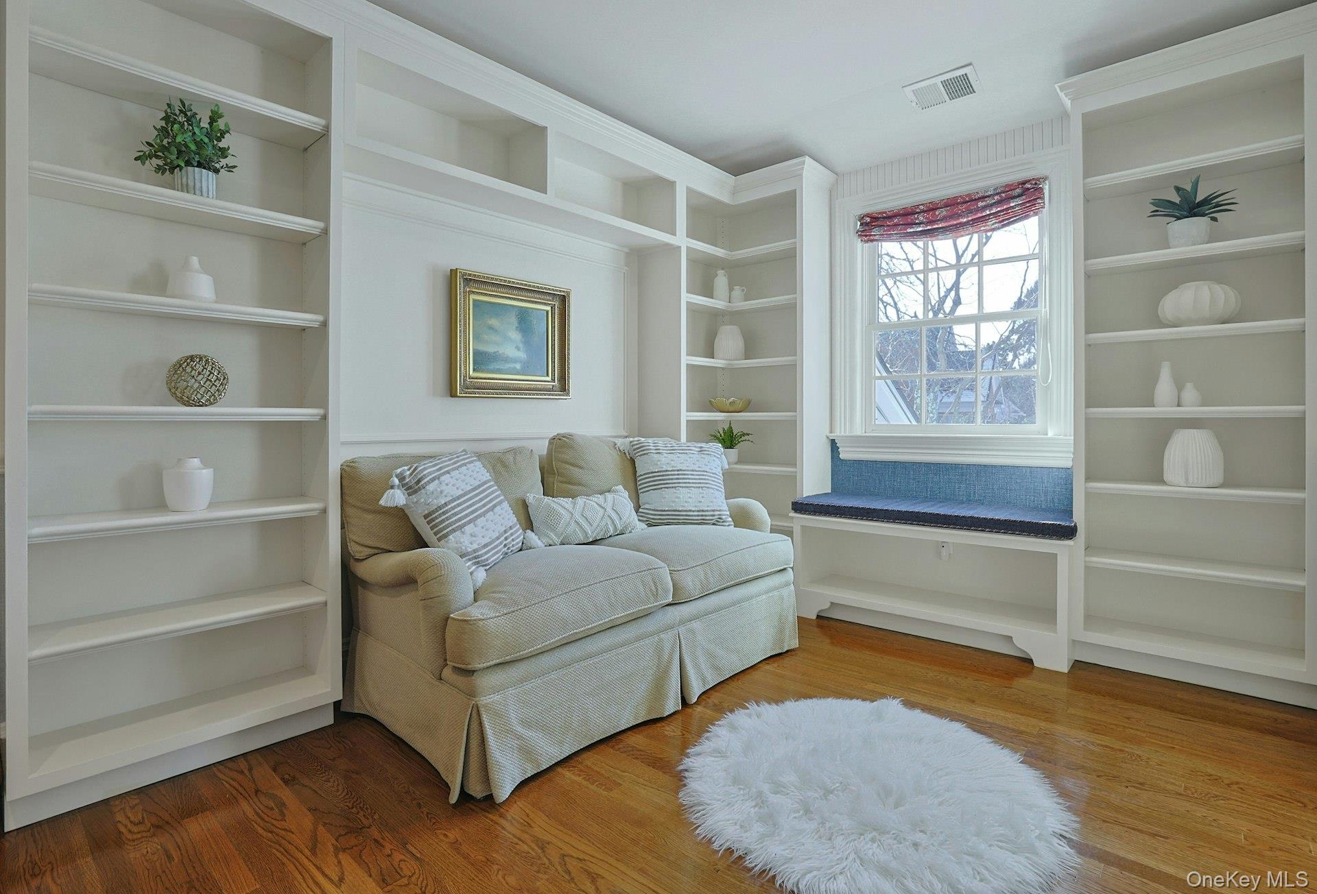 24 Fairview Road Scarsdale, NY 10583 - Photo 29 of 48 A cozy reading nook tucked beside the back staircase, featuring custom built-in bookshelves and a wonderfully inviting atmosphere.