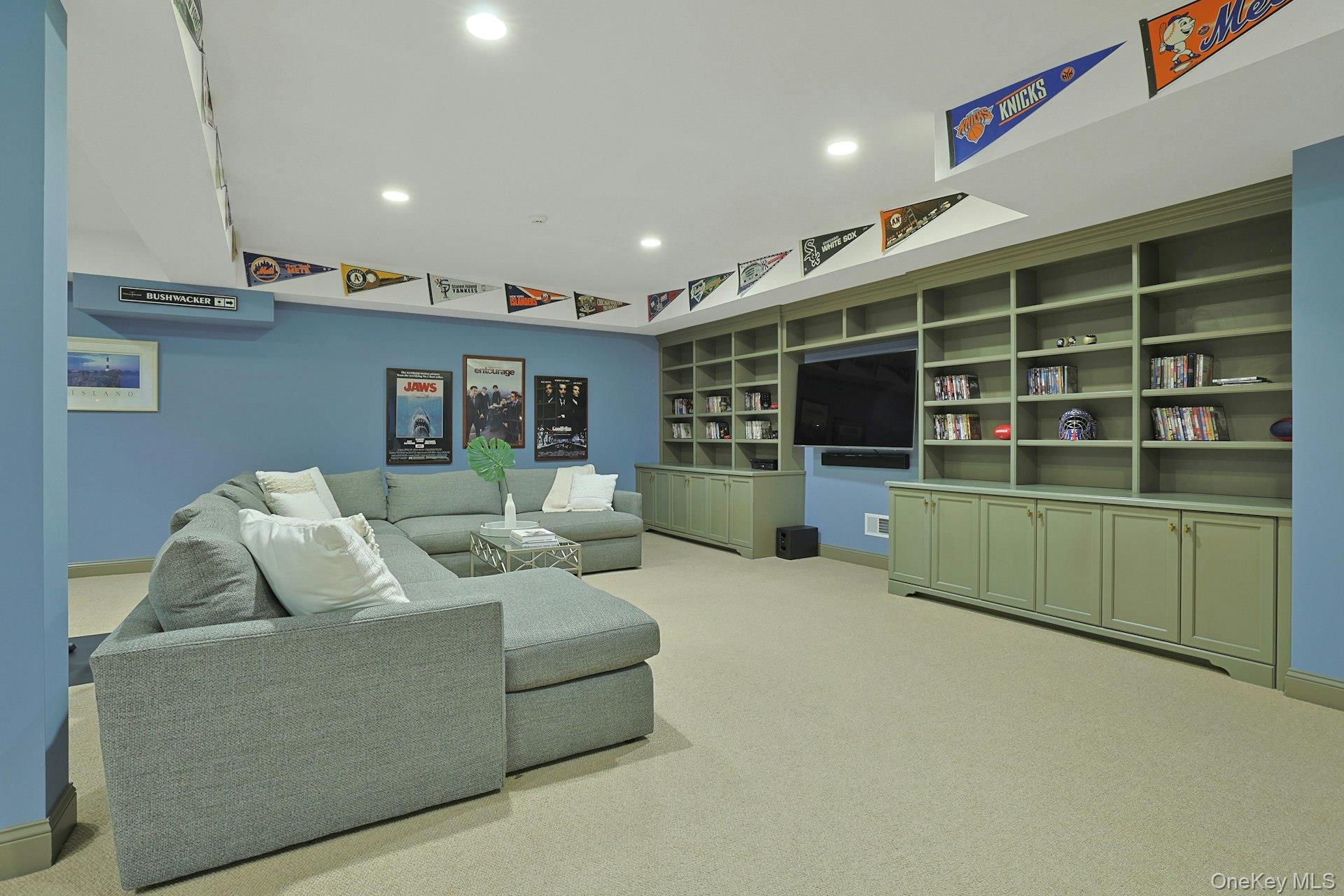 24 Fairview Road Scarsdale, NY 10583 - Photo 34 of 48 Comfortable media and lounge area featuring custom built-in cabinetry—perfect for movie nights and relaxed evenings.